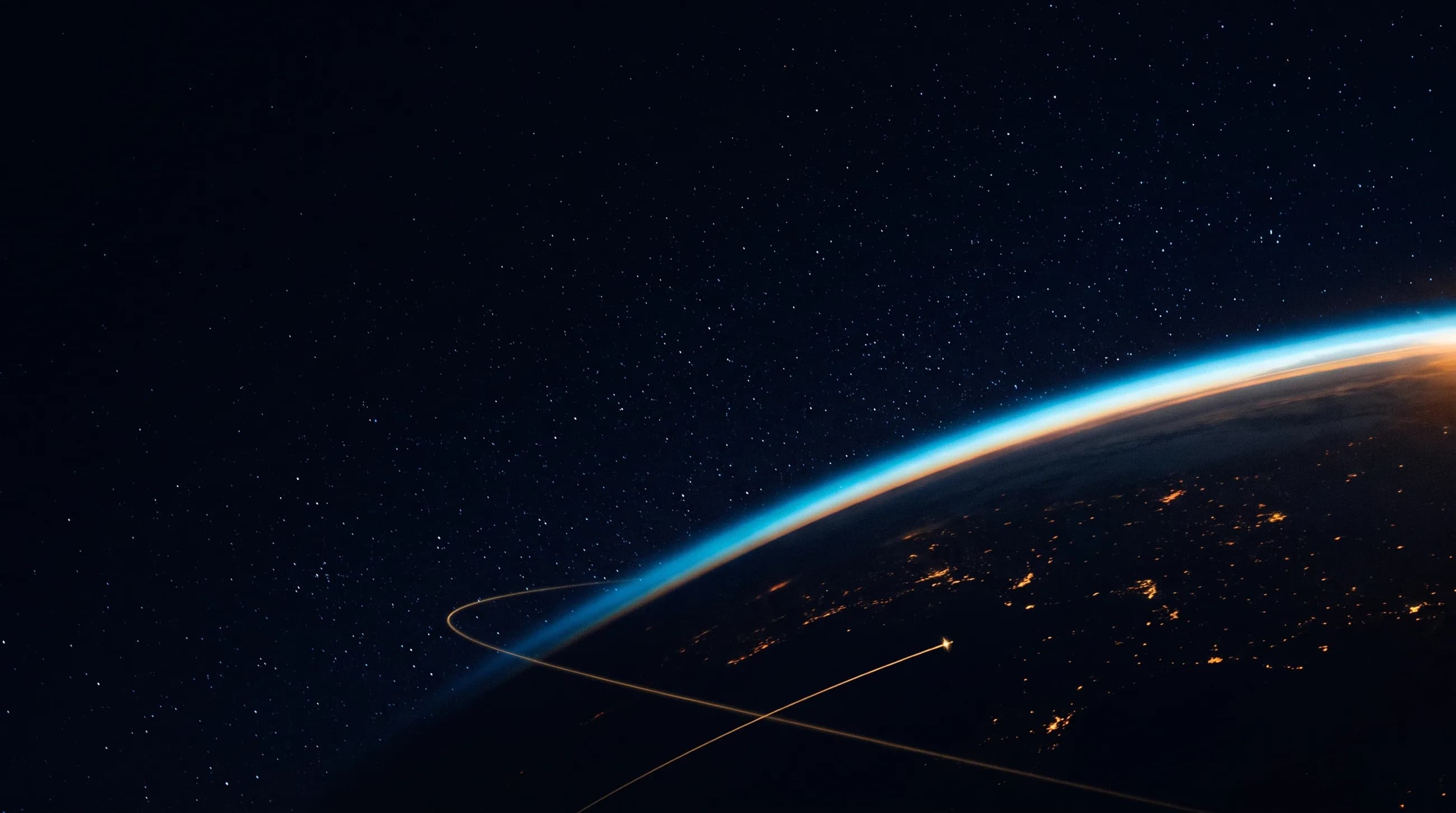 Earth at night seen from orbit, with a traced satellite path across the atmosphere